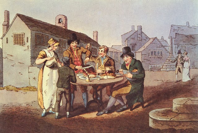 A lady pours out ale as a boy stands nearby. Two men sit at a table and another man carves mat while standing.